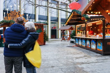 Wall Mural - Senior Couple at Christmas Market at Kaiser Wilhelm Memorial Berlin