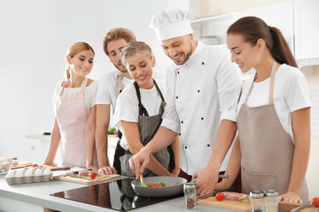 Wall Mural - Group of people and male chef at cooking classes