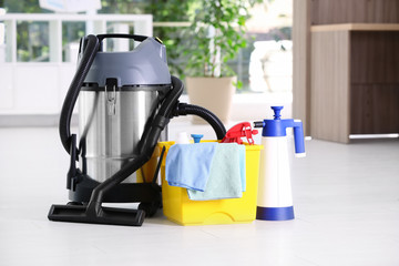 Canvas Print - Vacuum cleaner and detergents on floor indoors