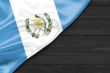 Wall Mural - Flag of Guatemala and place for text on a dark wooden background