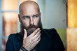 © GVS - Portrait of bearded thoughtful man strokes beard