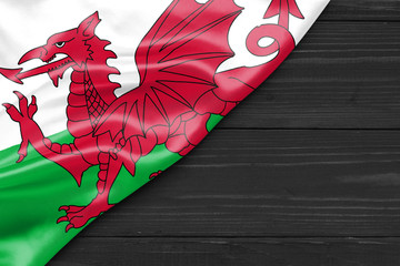 Flag of Wales and place for text on a dark wooden background