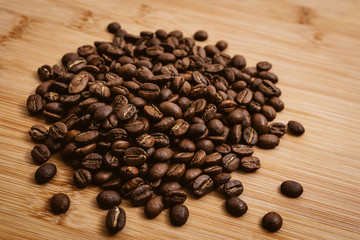 Wall Mural - Coffee beans roasted on a wooden table with much of beans with a great aroma