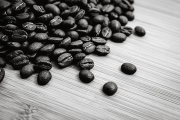 Wall Mural - Coffee beans roasted on a wooden table with much of beans with a great aroma