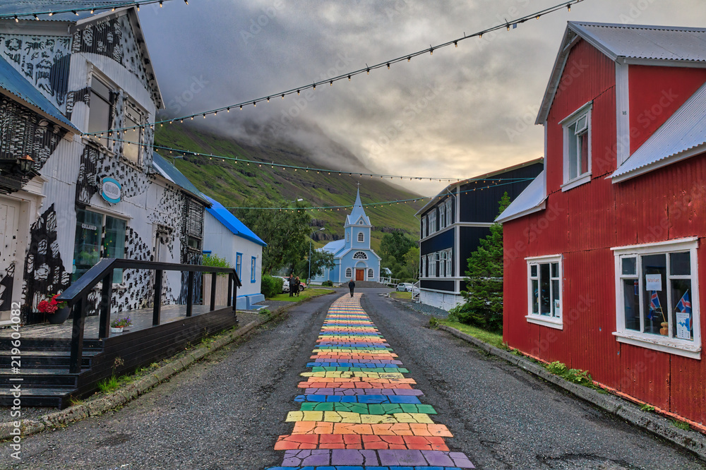 Obraz na płótnie Rainbow pathway in center of town to Seyðisfjarðarkirkja Church w salonie