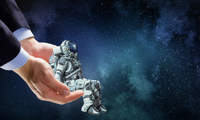 Wall Mural - spaceman on finger. mixed media