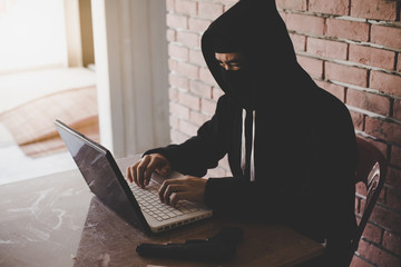 computer hacker who wears financial information theft hat.