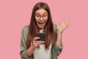 overjoyed happy excited female glad to recieve text message informing about salary, rejoices good ne