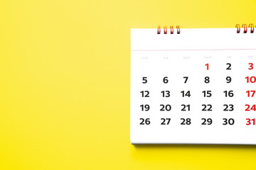 close up of calendar on yellow background, planning for business meeting or travel planning concept