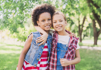 Wall Mural - Two little girls hugging in the park