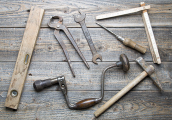 Wall Mural - Old tools on a wooden background