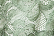 Top View Over Green Lace Textil Texture With Ornament. Macro Shot