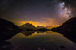 Milky Way and Starry Sky over Iconic Snowy Mont-Blanc Peaks Reflecting in Altitude Lake.