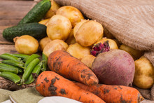 Fresh Healthy Raw Vegetables, Close Up. Dirty Carrots, Potatoes, Beetroot, Cucumbers And Peas.