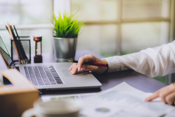 Wall Mural - The accountant checking documents about graph and chart relating to financial reporting and tax accounting of the company