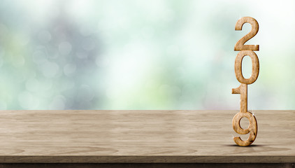 Poster - New year 2019 wood number (3d rendering) on wooden table at blur abstract green bokeh background,Mock up banner space for display or montage of product,holiday celebration greeting card.