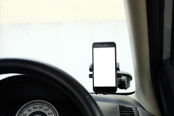 Mockup Smartphone in a car use for Navigate or GPS. Smartphone in holder. Mobile phone with isolated white screen.