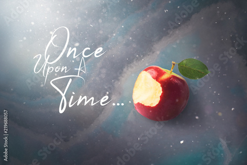Fairy tale tale concept with poisoned bitten red apple laying on marble Tableau sur Toile
