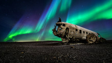 Northern lights over plane wreckage in Iceland