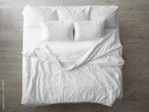 Fotomural Comfortable bed with soft pillows indoors, top view