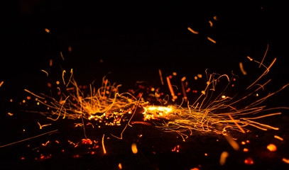 Flame of fire with sparks on a black background