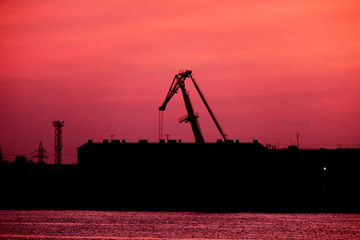 Silhouette Of port Crane In Front Of Red Sunset Sky