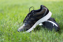 Pair Of Man Sport Shoes On Green Grass Field