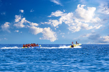 Water Amusement On Banana Boat. Summer Holiday By The Sea. Water Fun Concept.