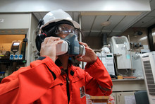 Multi-purpose Respirator Half Mask For Toxic Gas Protection.The Man Prepare To Wear Multi-purpose Half Mask.