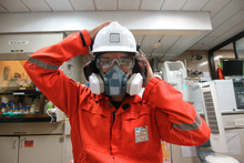 Multi-purpose Respirator Half Mask For Toxic Gas Protection.The Man Prepare To Wear Multi-purpose Respirator Half Mask.
