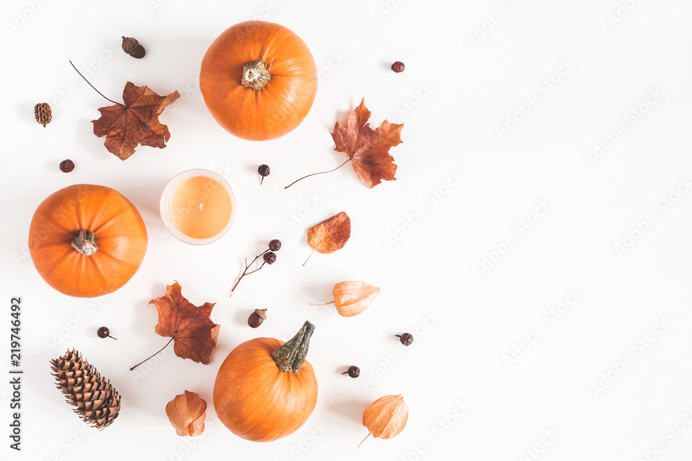 Autumn composition. Pumpkins, candles, dried leaves on white background. Autumn, fall, halloween concept. Flat lay, top view, copy space - obrazy, fototapety, plakaty 