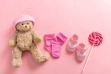 Wall Mural - Baby girl shoes and socks on pink background