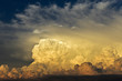 Gorgeous close up view of fluffy cumulus clouds with pink and yellow hues/ Above the clouds