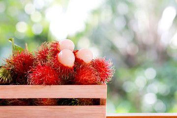 Wall Mural - Fresh rambutan in the wooden box, asian fruit.