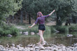 © ADDICTIVE STOCK - Pretty red haired girl performs exercises by the river.