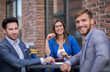 © ASDF - employees of the company sitting at a table in a street cafe