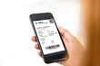 © Atstock Productions - Passenger looking at electronic boarding pass on smartphone screen