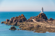 La Corbiere Lighthouse On The Island Of Jersey At Low Tide