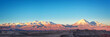 Panorama of Moon Valley in Atacama desert at sunset, snowy Andes mountain range in the background, Chile