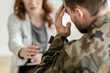 © Photographee.eu - Depressed soldier with suicidal thoughts wearing green uniform during therapy with psychiatrist