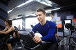 © Pixel-Shot - Young man training on special sport equipment in gym