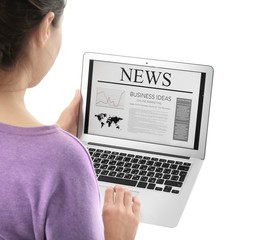 Woman reading news on laptop against white background