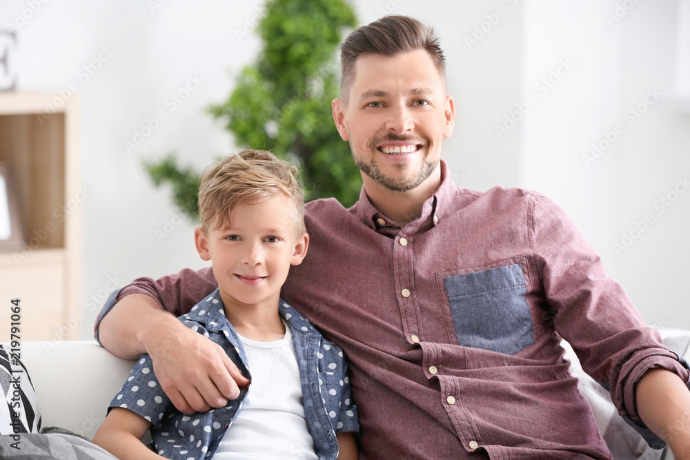 Little boy and his dad spending time together at home