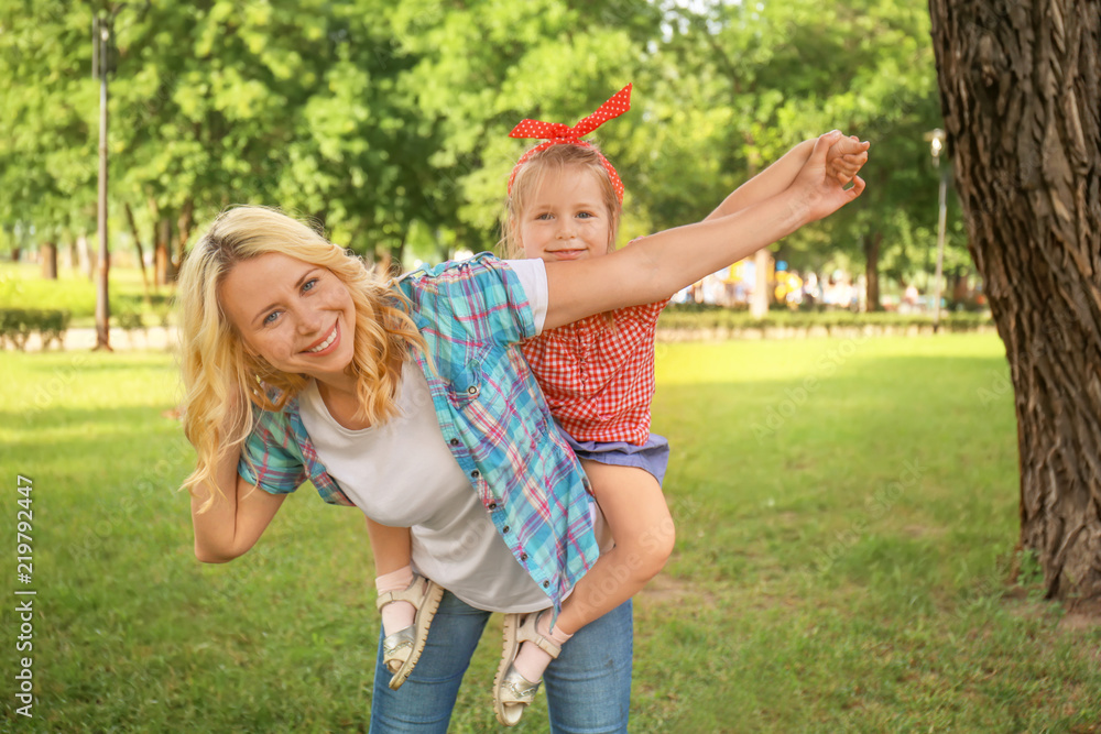 Happy mother with daughter in green park