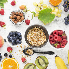 Wall Mural - Ingredients for healthy breakfast meals: raspberries, blueberries, nuts, orange, bananas, grapes blue, green, apples, kiwi. Top View.