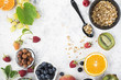 Ingredients for healthy breakfast meals: raspberries, blueberries, nuts, orange, bananas, grapes blue, green, apples, kiwi. Top View.