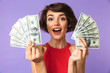 © Drobot Dean - Happy Pretty brunette woman showing money while looking at camera