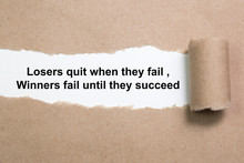 Motivational Quote Losers Quit When They Fail Winners Fail Until They Succeed Appearing Behind Paper.