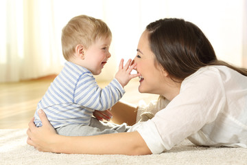 Affectionate mother and baby playing together