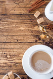 Fototapeta Mapy - Cup of coffee, brown sugar and cinnamon with anise on a wooden background. Copy space